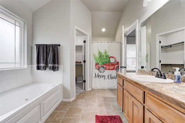 bathroom with vanity, plenty of natural light, and lofted ceiling