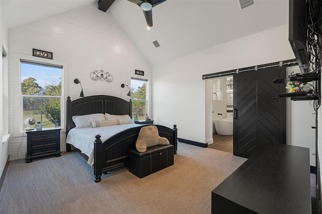 carpeted bedroom featuring beam ceiling, ceiling fan, a barn door, high vaulted ceiling, and ensuite bathroom