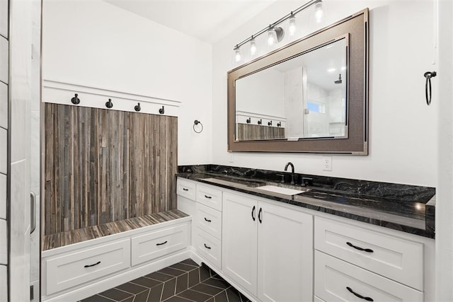 bathroom with tile patterned floors, vanity, and a shower