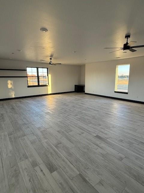 empty room featuring ceiling fan and light hardwood / wood-style floors