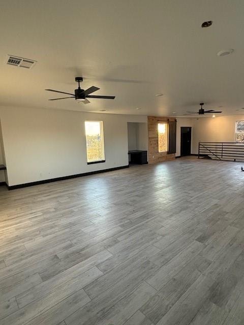 unfurnished living room featuring light hardwood / wood-style flooring and ceiling fan