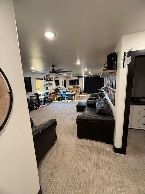 carpeted living room featuring ceiling fan