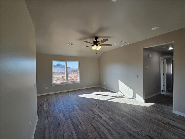 empty room featuring ceiling fan, dark hardwood / wood-style flooring, and lofted ceiling