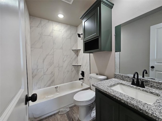 full bathroom featuring toilet, vanity, and tiled shower / bath