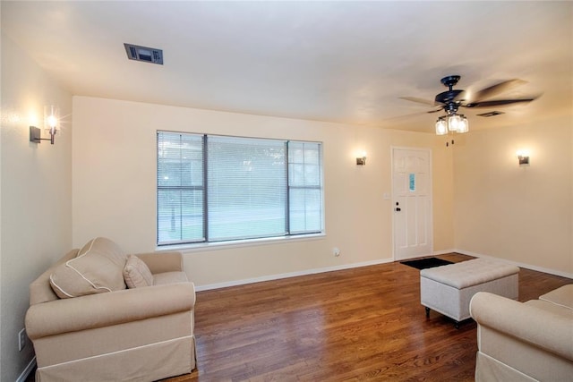 living room featuring dark hardwood / wood-style floors and ceiling fan