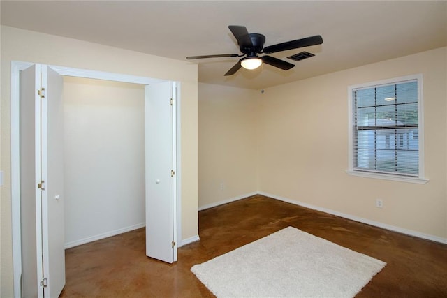 unfurnished bedroom featuring ceiling fan and dark colored carpet