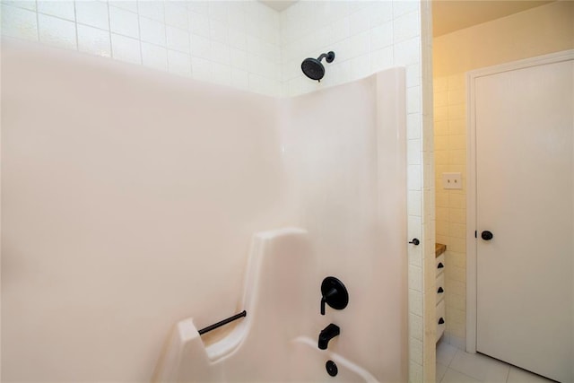 bathroom with tile patterned floors and tiled shower / bath