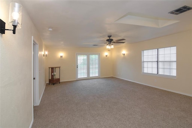 unfurnished room with ceiling fan and carpet floors