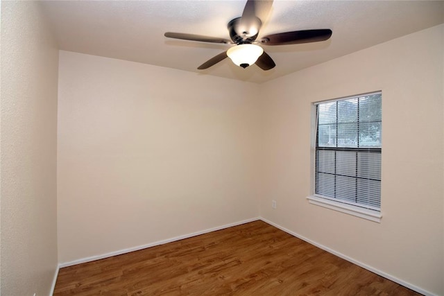 empty room with ceiling fan and wood-type flooring