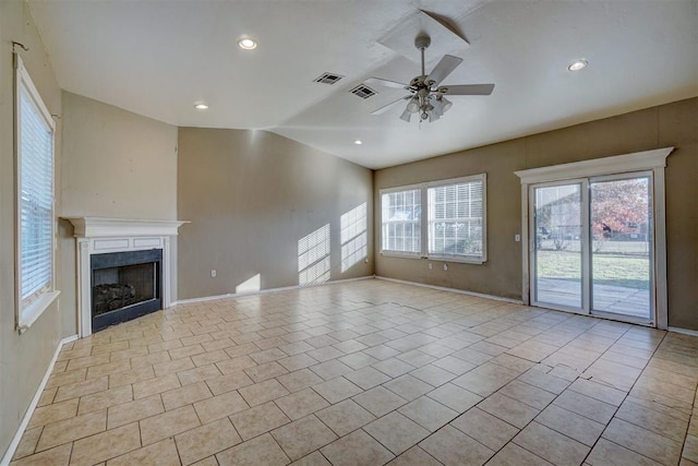 unfurnished living room featuring ceiling fan, a healthy amount of sunlight, and light tile patterned flooring