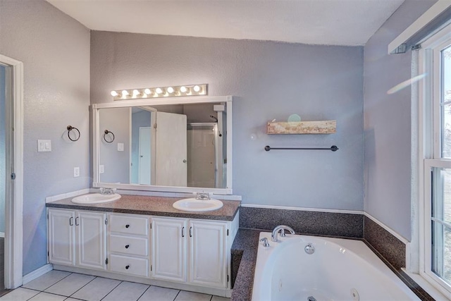 bathroom with plus walk in shower, vanity, and tile patterned floors