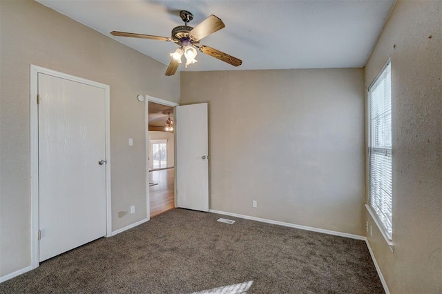 unfurnished room with carpet, a wealth of natural light, and ceiling fan