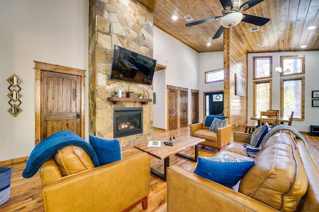 living room featuring light hardwood / wood-style floors, wood ceiling, and high vaulted ceiling