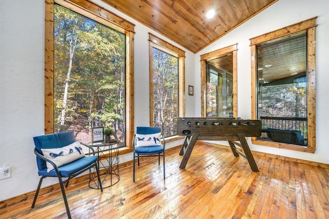 living area featuring light hardwood / wood-style floors, lofted ceiling, and wood ceiling