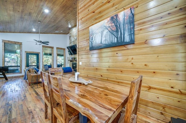 dining room featuring wood-type flooring, vaulted ceiling, ceiling fan, and wooden ceiling