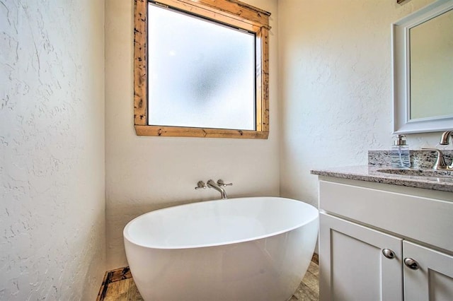 bathroom with a bath and vanity