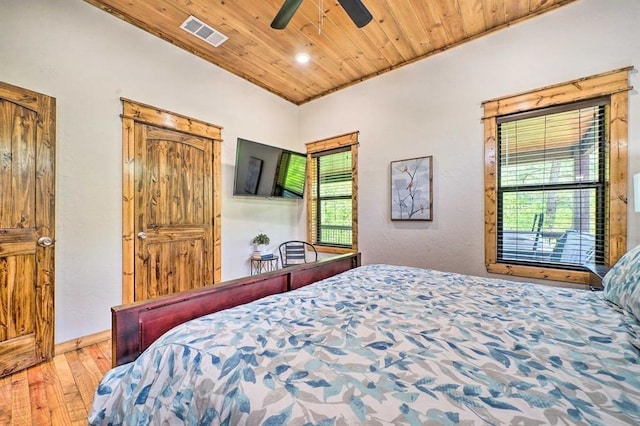 bedroom with multiple windows, ceiling fan, light hardwood / wood-style flooring, and wood ceiling