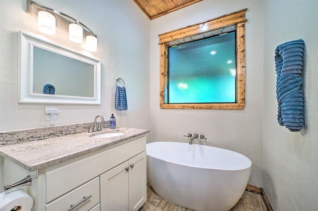 bathroom featuring vanity, wood-type flooring, wooden ceiling, and a tub