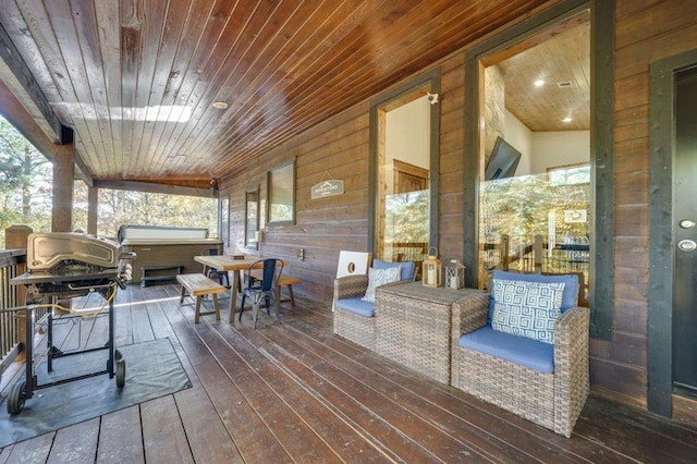 wooden terrace with a hot tub