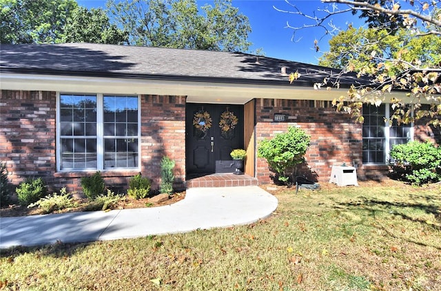 property entrance with a yard