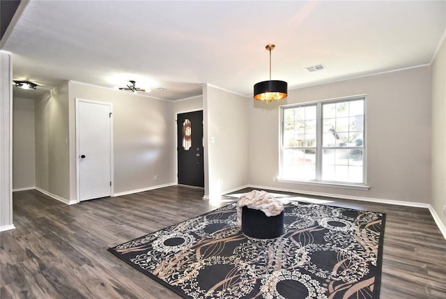 entryway with dark hardwood / wood-style flooring and ornamental molding