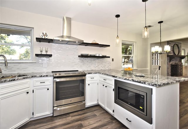 kitchen featuring white cabinets, stainless steel appliances, and a wealth of natural light