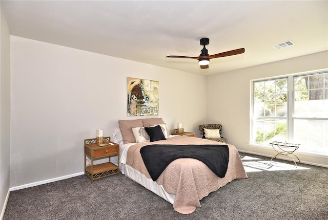 bedroom featuring ceiling fan and dark carpet