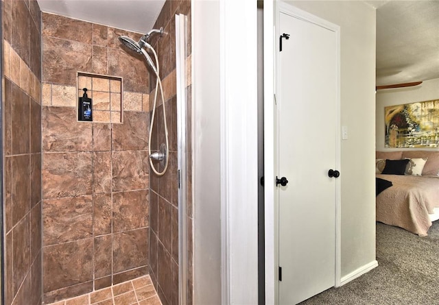 bathroom with ceiling fan and tiled shower