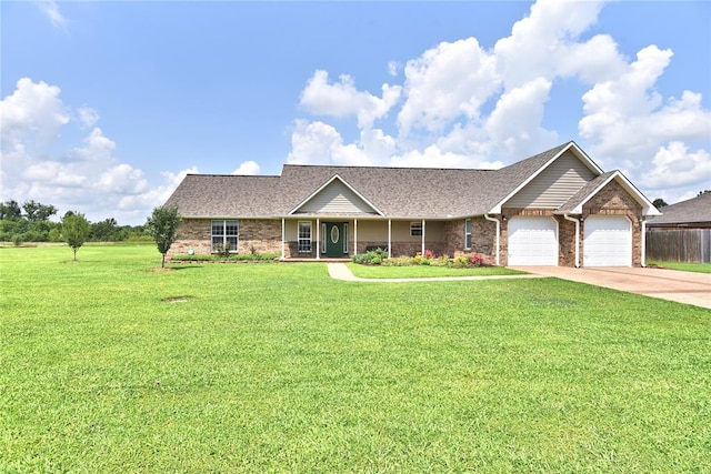 ranch-style house featuring a front yard and a garage