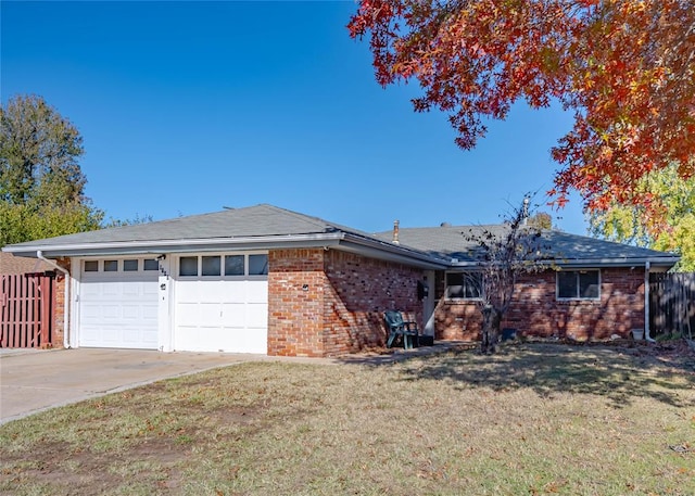 ranch-style house featuring a garage and a front lawn