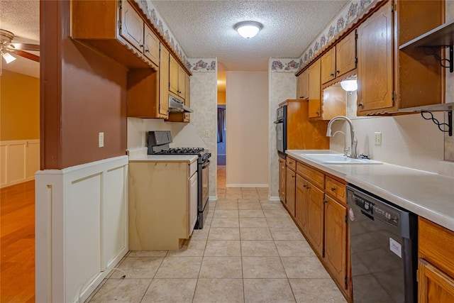 kitchen featuring ceiling fan, sink, black appliances, and a textured ceiling