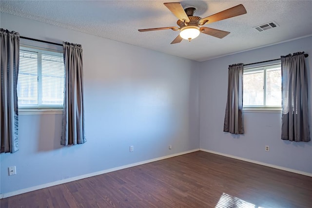 unfurnished room featuring a textured ceiling, dark hardwood / wood-style floors, and ceiling fan