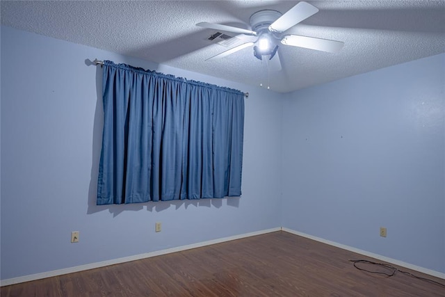 unfurnished room featuring ceiling fan, dark hardwood / wood-style flooring, and a textured ceiling