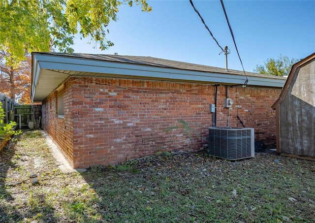 view of side of home featuring central AC