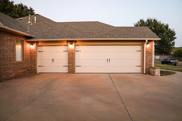 garage featuring concrete driveway