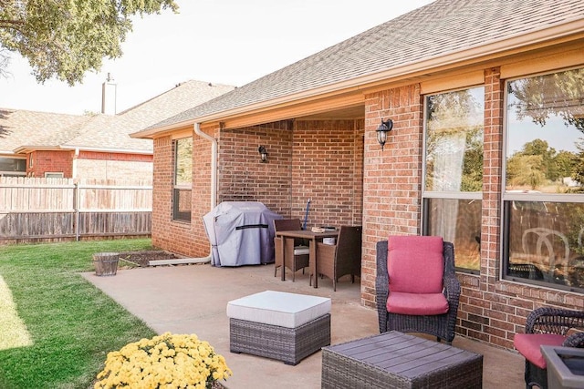 view of patio / terrace with a grill and fence