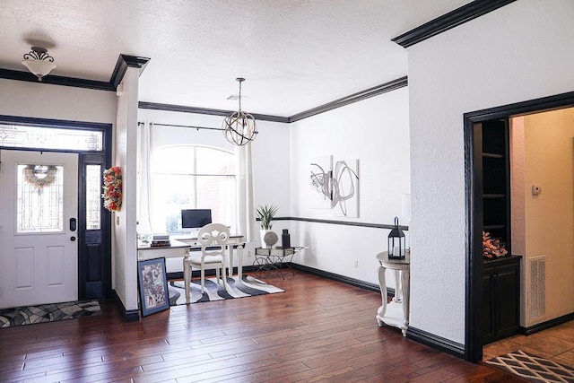 entrance foyer with visible vents, a textured ceiling, crown molding, and dark wood finished floors