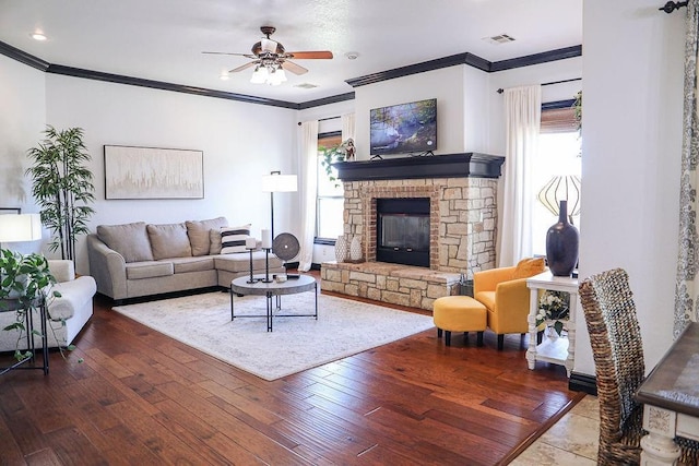 living room featuring visible vents, ceiling fan, a glass covered fireplace, and wood-type flooring