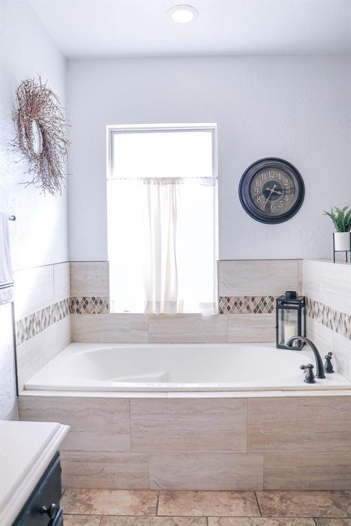 full bath with a garden tub