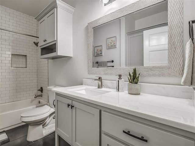 full bathroom featuring tile patterned flooring, vanity, toilet, and tiled shower / bath