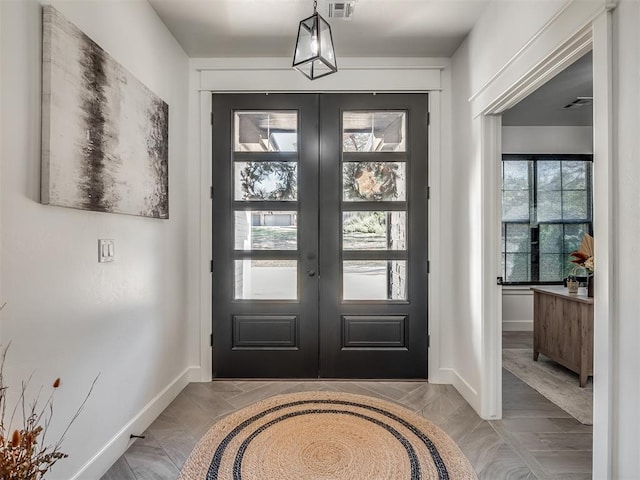 entryway featuring plenty of natural light, light wood-type flooring, and french doors