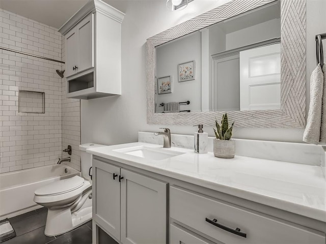 full bathroom with tiled shower / bath combo, vanity, tile patterned floors, and toilet