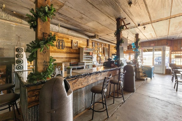 kitchen with wood walls and concrete flooring