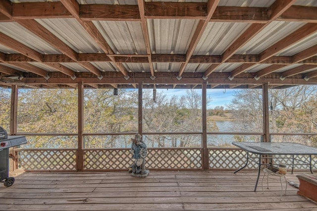 unfurnished sunroom featuring a water view