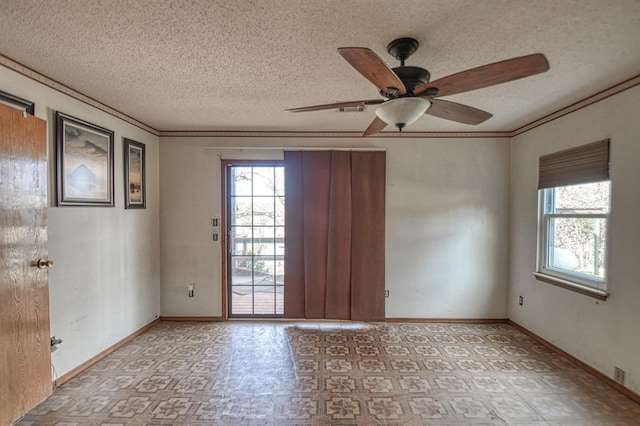 unfurnished room featuring ceiling fan, ornamental molding, and a textured ceiling