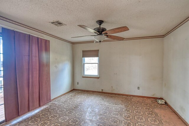 spare room featuring a textured ceiling, ceiling fan, and crown molding