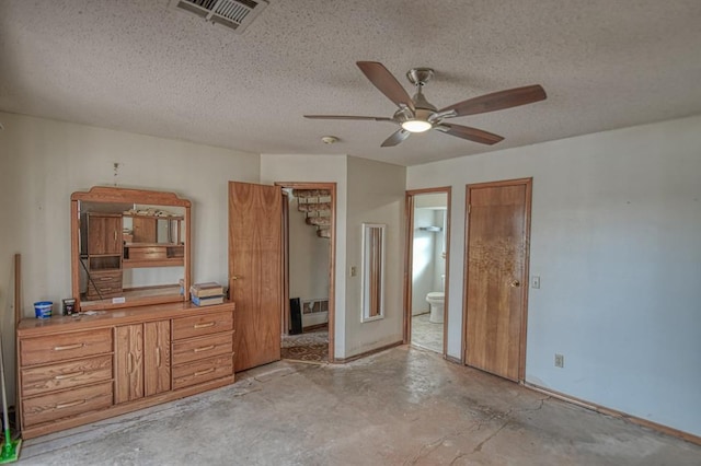 unfurnished bedroom featuring connected bathroom, ceiling fan, and a textured ceiling