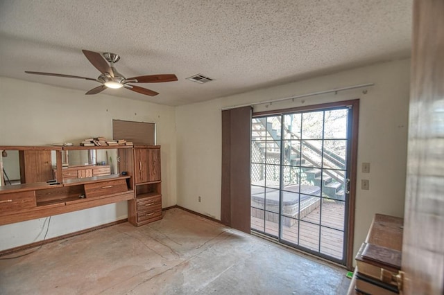 interior space with ceiling fan and a textured ceiling