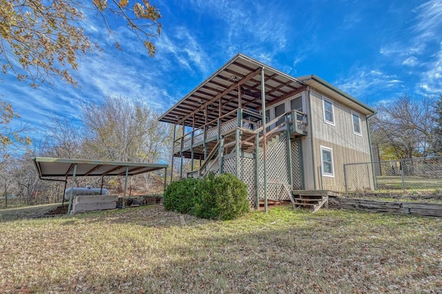 view of side of home with a lawn