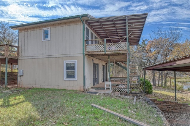 rear view of house with a lawn and a wooden deck